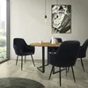A dining room scene with a round wooden table and four black velvet chairs. Náhled obrázku produktu