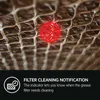 Close-up of a filter with a red indicator light and text overlay describing a filter cleaning notification. Voir les images du produit