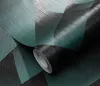 A roll of wallpaper with a geometric pattern in teal and black. Produktbild-Vorschau