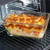 A close-up shot of a glass baking dish filled with a casserole, placed on an oven rack inside an oven. Produktbild-Vorschau