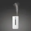 A white humidifier emitting a stream of mist against a dark gray background. Náhled obrázku produktu