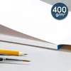 A close-up view of a white paper pad with art supplies. Produktbild-Vorschau