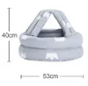 A baby helmet with a crown pattern, shown with dimensions. Produktbild-Vorschau