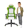 A young boy stands next to a gaming chair.