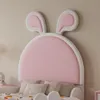 A close-up view of a child's bed headboard with pink bunny ears. Anteprima dell’immagine prodotto