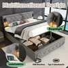A grey upholstered bed with storage, featuring integrated lighting and charging ports. Produktbild-Vorschau