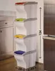 A stack of four BAMA Papierkorb POKER bins with different colored lids, placed in a kitchen setting. Náhľad obrázku produktu