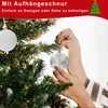 Hands decorating a Christmas tree with ornaments. Voir les images du produit