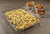 A metal rack filled with french fries, with three small bowls of snacks in the background. Voir les images du produit