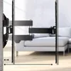 A black TV wall mount is shown extended from a concrete wall, with a sofa visible in the background. Voir les images du produit