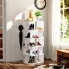 A white rotating shoe rack filled with various shoes, placed in a well-lit room with a window and a clock on the wall. Podgląd zdjęcia produktu