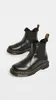 A pair of black Dr. Martens Chelsea boots with faux fur trim, shown against a white background. Produktbild-Vorschau
