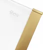 A close-up view of a shower enclosure corner with a gold-colored metal frame and a white glass panel. The brand name 'Rea' is subtly visible on the glass. Produktbild-Vorschau