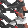 A close-up view of two different types of shoes attached to the pedals of an indoor cycling bike. Produktbild-Vorschau