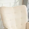 Close-up view of the textured fabric of a beige armchair. Produktbild-Vorschau