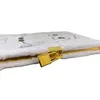 A close-up side view of a plush A5 notebook with a gold lock. Produktbild-Vorschau