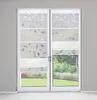 A pair of white sliding glass doors with decorative blinds featuring a leaf pattern. Produktbild-Vorschau