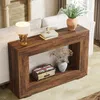 A console table with decorative items placed on and inside it, situated next to a sofa in a living room setting. Produktbild-Vorschau