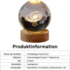 A crystal ball with a galaxy engraving on a wooden base, illuminated from within. Produktbild-Vorschau