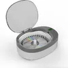 A digital display and control buttons are visible on the gray top of the ultrasonic cleaner. Produktbild-Vorschau