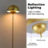 A floor lamp with a golden parabolic shade and stem, shown in a close-up view with descriptive text. Voir les images du produit