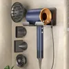 A hair dryer and its accessories are mounted on a wall holder. Produktbild-Vorschau