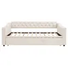 A beige upholstered daybed with a tufted backrest and a pull-out trundle bed. Náhľad obrázku produktu