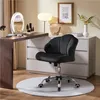 A black ergonomic office chair is placed in front of a desk with a makeup mirror and various cosmetics. Produktbild-Vorschau