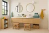 A modern bathroom with a double vanity, mirrors, and wooden accents. Produktbild-Vorschau