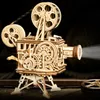A wooden model of a film projector is shown with a beam of light emanating from the lens. Produktbild-Vorschau
