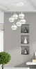 A modern interior scene featuring a multi-pendant chandelier and decorative vases in wall niches. Produktbild-Vorschau