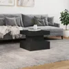A modern living room scene with a grey sectional sofa and a black coffee table. Produktbild-Vorschau