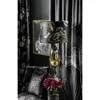 A luxurious interior scene featuring dark floral patterned curtains, a framed artwork, a decorative lamp, and a plush cushion with a floral motif, alongside a vase of deep red flowers. Produktbild-Vorschau