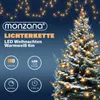 A decorated Christmas tree with lights and promotional text about a light chain. Produktbild-Vorschau