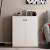 A white cabinet with two doors is shown in a room setting. Podgląd zdjęcia produktu