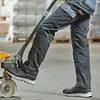 A person is using a pallet jack in a warehouse. Podgląd zdjęcia produktu