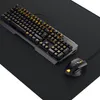 A gaming keyboard and mouse set on a black desk mat. Produktbild-Vorschau