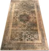 A Persian-style rug with intricate patterns in cream, beige, and dark blue. Voir les images du produit