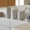 A bathroom countertop with various accessories. Produktbild-Vorschau