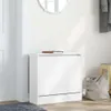 A white shoe cabinet is shown in a hallway setting, with a mirror on the wall and a bag on the floor. Produktbild-Vorschau