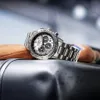 A close-up shot of a Citizen chronograph watch resting on a textured surface, with a blurred background. Podgląd zdjęcia produktu