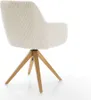 A close-up side view of a beige corduroy armchair with a wooden base. Produktbild-Vorschau