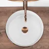 A top-down view of a white basin with a rose gold faucet and drain. Produktbild-Vorschau