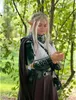 A person dressed in a medieval knight costume with accessories, standing in a forest. Náhled obrázku produktu