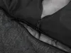 A close-up view of a dark gray dog bed, showing the texture of the fabric and a zipper. Náhľad obrázku produktu