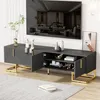 A modern living room setup featuring a black TV stand with gold accents, a large television, and decorative items. Produktbild-Vorschau