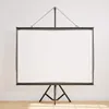 A white projection screen with a black tripod stand is shown against a white wall and wooden floor. Podgląd zdjęcia produktu