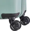 Close-up view of the wheels and bottom corner of a light green suitcase. Náhľad obrázku produktu