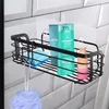 A black metal shower caddy filled with various bath products, hanging on a tiled wall. Náhled obrázku produktu