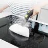 A person is cleaning a glass stovetop with a steam cleaner. Náhled obrázku produktu